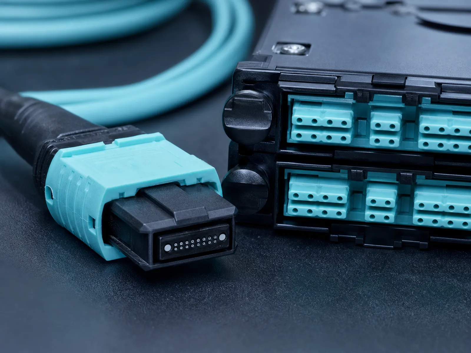 Macro view of a multi-fiber MPO/MTP connector and a fiber cassette in a high-density data center panel, the layer behind the reach spec